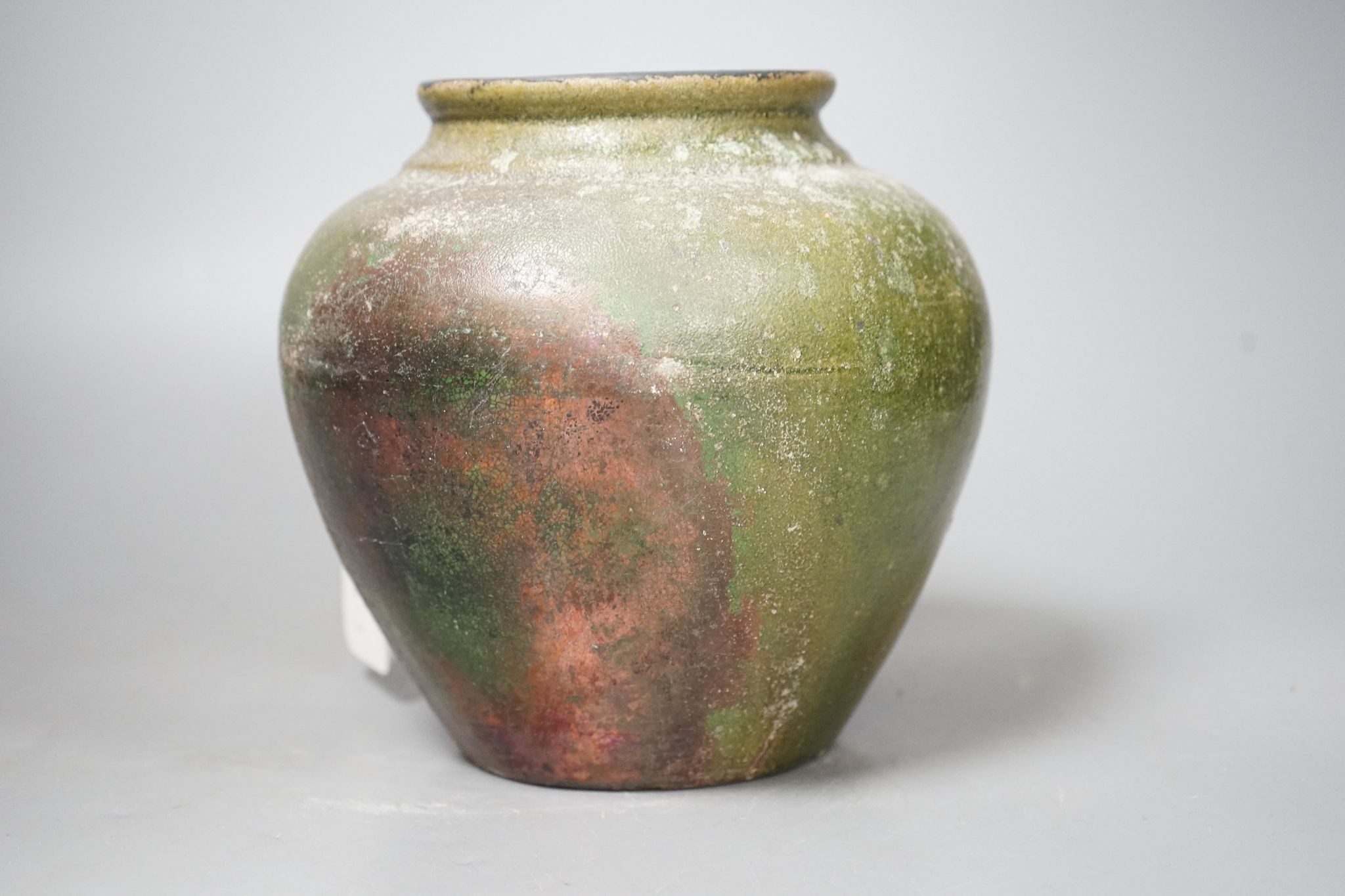 A copper lustre and green glazed pottery jar, 17.5cm high